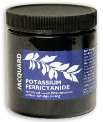 A plastic jar labeled Jacquard Potassium Ferricyanide, used for cyanotype chemistry, with a blue and white color scheme.